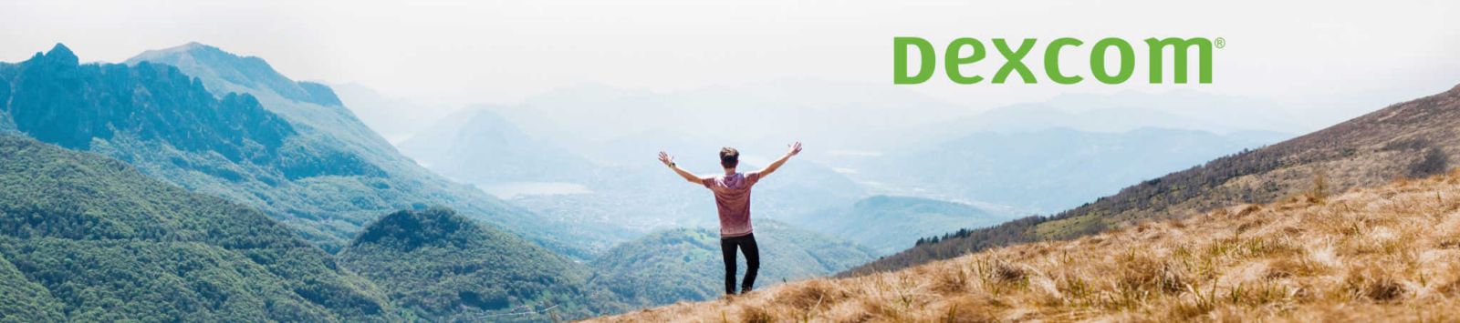 Image of man standing outside looking out at nature