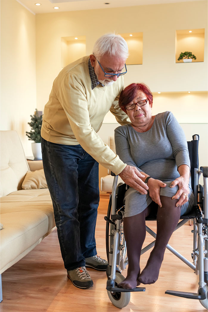 Staff assisting woman with cane