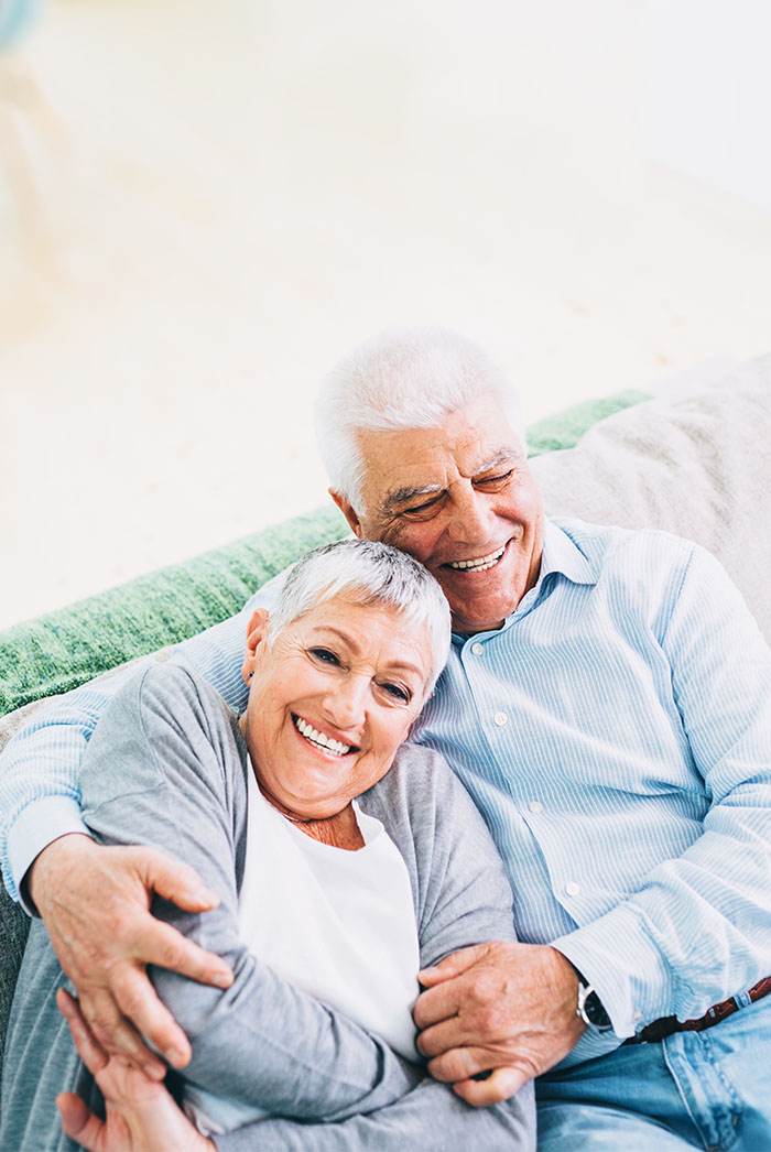 Man and woman sitting together on couch